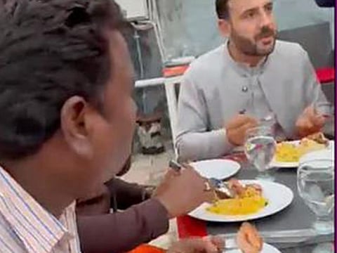 Tahir Khan, the host, chats with the Indians in his restaurant.