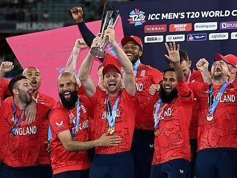 England's captain Jos Buttler (centre) holds the trophy as he celebrates with his players after victory over Pakistan in the ICC men's Twenty20 World Cup 2022 final cricket match at The Melbourne Cricket Ground (MCG) in Melbourne.