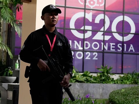 An Indonesian soldier walks past a G20 sign at one of the venues of the G20 leaders summit, in Nusa Dua, Bali, Indonesia, Monday, Nov. 14, 2022