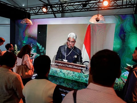 People watch as India's Union Cabinet Minister for Environment, Forest & Climate Change Bhupender Yadav speaks at a news conference, as India publishes a long term emissions strategy, during the COP27 climate summit, in Sharm Al Sheikh on November 14, 2022.