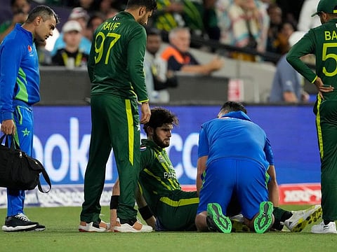 Pakistan's Shaheen Shah Afridi is attended by members of support staff after he was injured while taking a catch in the final against England in Melbourne on Sunday.