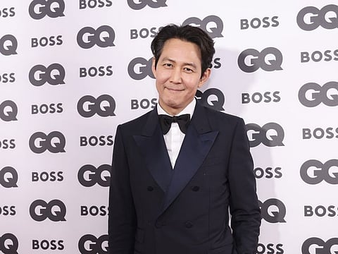 Lee Jung-jae poses for photographers upon arrival at the GQ Men of the Year 2022 event in London, Wednesday, November 16.