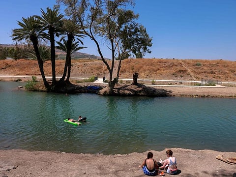 A file photo taken on July 13, 2021 shows Israelis camping by the Jordan River near Kibbutz Degania, off the Sea of Galilee, or Lake Tiberias, one of the main water sources in Israel.