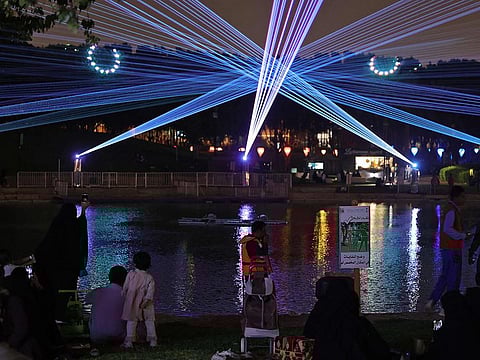 Saudis attending the Noor Riyadh lighting festival held at Al Salam Park in the Saudi capital Riyadh as part of Riyadh Season activities.