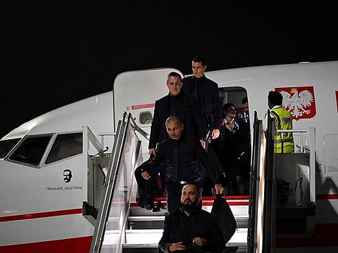 Poland team members arrive at the Hamad International Airport in Doha on November 17, 2022, ahead of the Qatar World Cup football tournament.