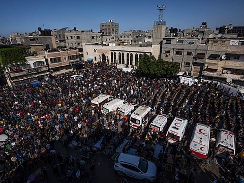 Mourners pray for a Palestinian family that died in a fire in their apartment building in the Jabaliya refugee camp, northern Gaza Strip, on Nov. 18, 2022.
