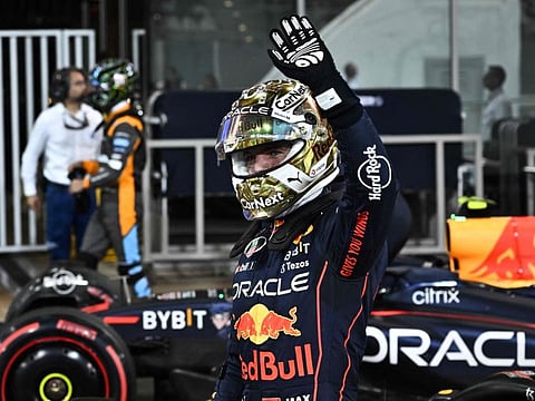 Red Bull's Dutch driver Max Verstappen waves to the crowd after qualifying in pole position for the Abu Dhabi Grand Prix to be held tomorrow at Yas Marina Circuit.