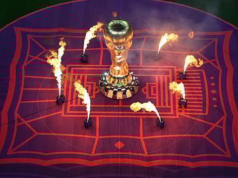 A FIFA World Cup trophy replica is pictured on the pitch as fireworks go off during the opening ceremony for the 2022 World Cup in Qatar at the Al-Bayt Stadium in Al Khor, north of Doha.