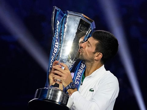 Serbia's Novak Djokovic poses with his trophy after defeating Norway's Casper Ruud 7-5, 6-3, in the singles final tennis match to win the ATP World Tour Finals at the Pala Alpitour, in Turin, Italy.