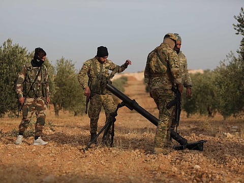 Turkey-backed Syrian fighters man a mortar in Jarabulus close to the border with Turkey in the rebel-held north of Syria's Aleppo province, on November 21, 2022.