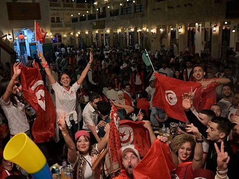 Tunisia supporters cheering their team on in Souq Waqif in Doha, during the Qatar 2022 World Cup football tournament.