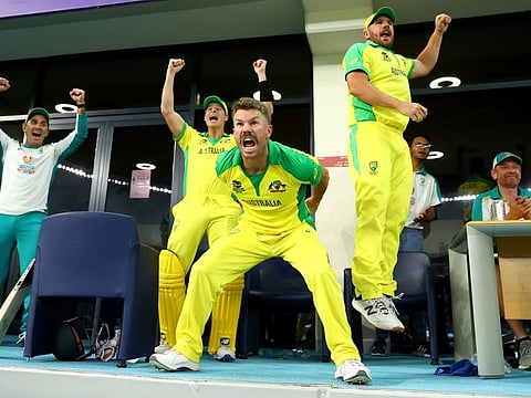 Australian team coach Justin Langer (left) celebrates with Steve Smith, David Warner and Aaron Finch after winning the ICC Men's T20 World Cup final against New Zealand in Dubai in 2021.