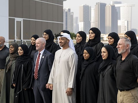 Sheikh Mohamed bin Zayed Al Nahyan, President of the United Arab Emirates, stands for a photograph with the UAE mountaineering team.