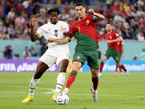 Ghana's Mohammed Salisu concedes a penalty against Portugal's Cristiano Ronaldo. Ronaldo scored to become the first player to score in five different World Cup finals.