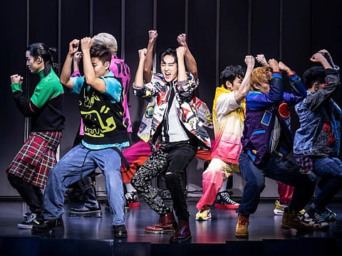 This image released by O+M/DKC shows Kevin Woo, center, and the cast during a performance of “KPOP,” opening November 27 at the Circle in the Square Theatre in New York.