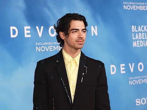 US actor-singer Joe Jonas arrives for the Los Angeles premiere of "Devotion" at the Regency Bruin Theatre in Los Angeles, California, on November 15, 2022.