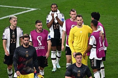 Germany's players react after their loss to Japan in Group E on Wednesday.