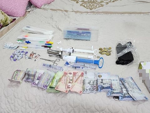 Cash and tools used to perform operations seized by authorities.