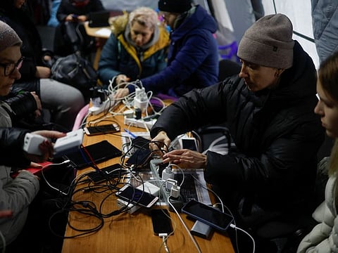 Local residents charge their devices, use internet connection and warm up inside an invincibility centre after critical civil infrastructure was hit by Russian missile attacks in Kyiv, Ukraine November 24, 2022.