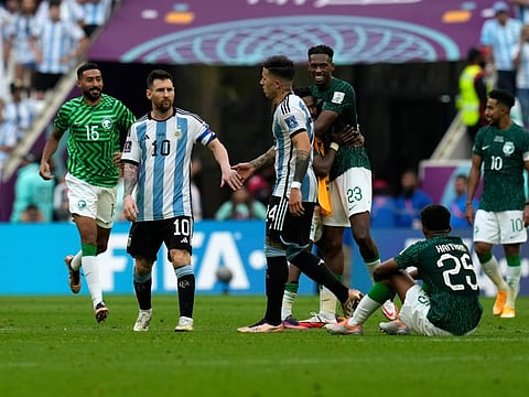 Argentina's Lionel Messi (second from left) and Enzo Fernandez wear a dejected look at the end of the World Cup Group C match against Saudi Arabia at Lusail Stadium on Tuesday.