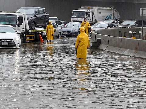 Vehicles drive through a flooded street following heavy rain, in Jeddah in a file photo.