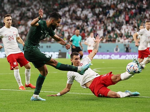 Saudi Arabia's Saleh Al-Shehri in action with Poland's Jakub Kiwior during the FIFA World Cup Qatar 2022 Group C at the Education City Stadium, Al Rayyan, Qatar.