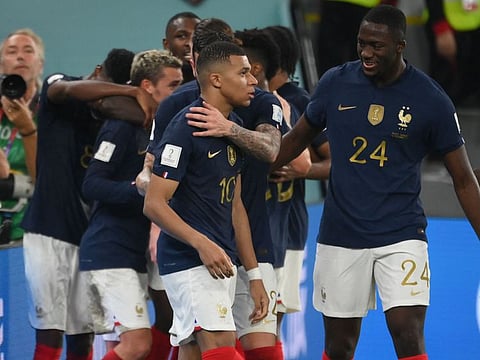 France's forward Kylian Mbappe (centre) celebrates with teammates after scoring his team's second goal during the Qatar 2022 World Cup Group D match against Denmark at Stadium 974 in Doha.