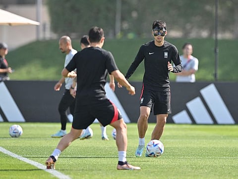 South Korea's midfielder Son Heung-min (right) takes part in a training session at the Al Egla Training Site 5 in Doha.