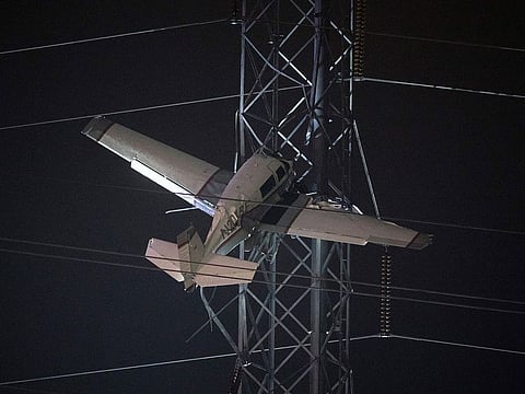 A small plane rests on live power lines after crashing in Montgomery Village.