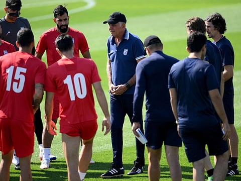 Iran's Portuguese coach Carlos Queiroz (centre) talks to players and staff during a training session at Al Rayyan SC in the Al Rayyan district in Doha.