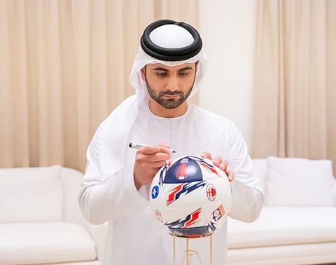 Sheikh Mansoor Bin Mohammed Bin Rashid Al Maktoum signs the official match ball for the inaugural Dubai Super Cup 2022.