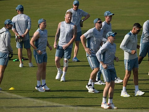 Englands captain Ben Stokes (centre) warms up along with teammates during a training session ahead of their first Test against Pakistan at the Rawalpindi Cricket Stadium on Monday.