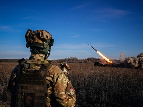 A Ukrainian soldier watches a self-propelled 220 mm multiple rocket launcher "Bureviy" firing towards the front line, eastern Ukraine on November 29, 2022.