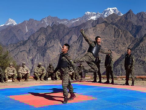US army soldiers of 2nd Brigade of the 11th Airborne Division watch Indian army soldiers display their unarmed combat skills during the Indo-US joint exercise or "Yudh Abhyas, in Auli, in the Indian state of Uttarakhand, Tuesday, Nov. 29, 2022.