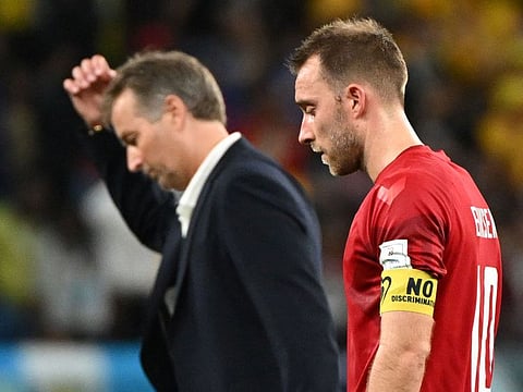 Denmark’s midfielder Christian Eriksen (right) and coach Kasper Hjulmand look dejected after Australia won the Qatar 2022 World Cup Group D football match at the Al Janoub Stadium in Al Wakrah, south of Doha, Qatar, on November 30, 2022. Denmark lost two games and drew one in the group stage to crash out of the tournament.