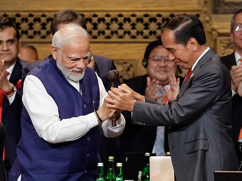 India's Prime Minister Narendra Modi, left, holds the gavel with Indonesia's President Joko Widodo during handover ceremony at the G20 Leaders' Summit, in Nusa Dua, Bali, Indonesia Nov. 16, 2022.