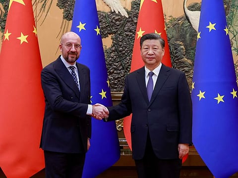 In this photo released by Xinhua News Agency, Chinese President Xi Jinping, right, shakes hands with European Council President Charles Michel before their meeting at the Great Hall of the People in Beijing, Thursday, Dec. 1, 2022.