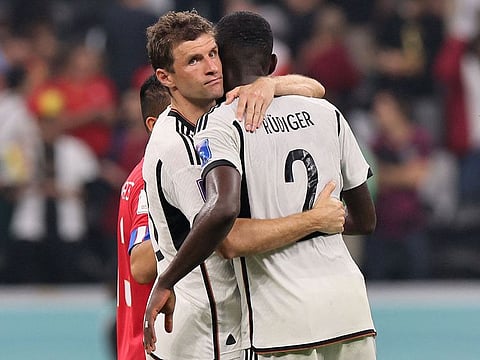 Germany's forward #13 Thomas Mueller (L) and Germany's defender #02 Antonio Ruediger reacts after they failed to qualify during the Qatar World Cup Group E football match between Costa Rica and Germany at the Al-Bayt Stadium in Al Khor.