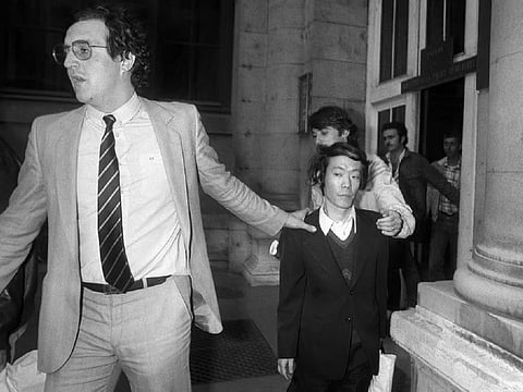 Issei Sagawa being escorted by French policemen in 1981.