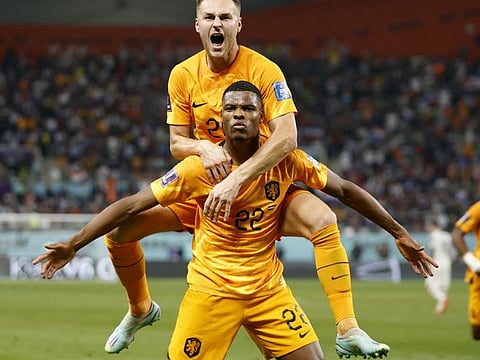 Netherlands' Denzel Dumfries celebrates scoring their third goal against USA with Teun Koopmeiners in their last 16 clash at Khalifa International Stadium, Doha, Qatar.