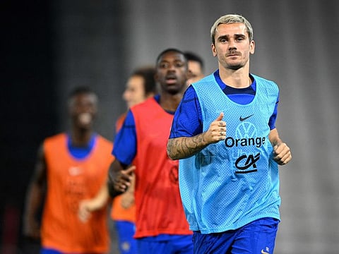 France's forward Antoine Griezmann (right) looks on during a training session at the Jassim-bin-Hamad Stadium in Doha.