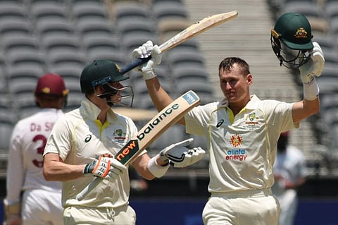 Australia's Marnus Labuschagne (right) celebrates his century with Steve Smith during the fourth day of the first cricket Test match against the West Indies at Perth Stadium in Perth.
