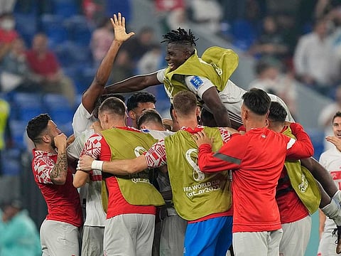 Switzerland's players celebrate after winning the World Cup group G soccer match between Serbia and Switzerland, at the Stadium 974 in Doha, Qatar, Friday, Dec. 2, 2022. Switzerland won 3-2.