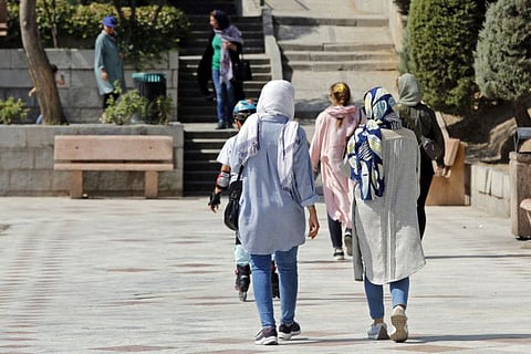 In this file photo taken on September 27, 2022, women walk at a park in Iran's capital Tehran.