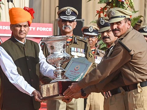 Minister of State for Home Affairs of India Nityanand Rai, Border Security Force Director General Pankaj Kumar Singh (2 left) presents trophy to BSF officers during the 58th BSF Raising Day at Guru Nanak Dev University in Amritsar on December 4, 2022.