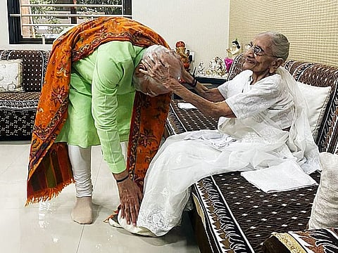 Prime Minister Narendra Modi seeks blessings from his mother Heeraben Modi, at her residence, in Gandhinagar on Sunday.