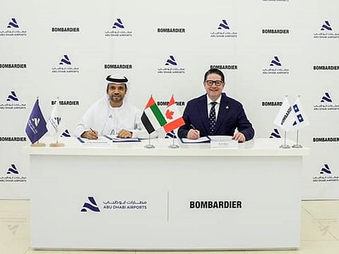 Jamal Salem Al Dhaheri and Eric Martel sign the agreement in Abu Dhabi.