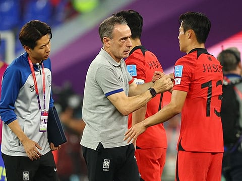South Korea coach Paulo Bento (centre) looks dejected after being eliminated from the World Cup.