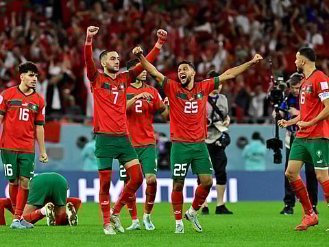 Morocco's players celebrate after beating Spain on penalties to reach the FIFA World Cup quarter-final.