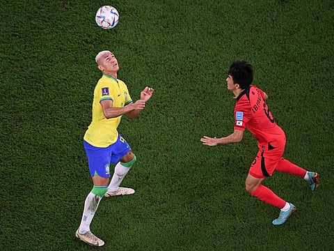 Brazil’s forward Richarlison (left) heads the ball in front of South Korea’s midfielder Hwang In-beom before setting up his goal in the FIFA World Cup Qatar 2022 Round of 16 match at Stadium 974 in Doha, on December 5, 2022. Richarlison scored the third goal in Brazi’l’s 4-1 win over South Korea.
